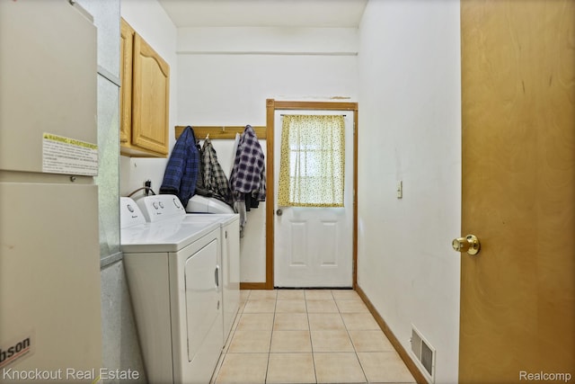 5490 Rupprecht Rd, Vassar, MI 48768 - washroom featuring cabinet space, washer and clothes dryer, and light tile patterned floors