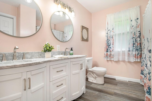 7920 8 1/2 Mile Rd, Ceresco, MI 49033 - full bathroom featuring double vanity, wood finished floors, and curtained shower