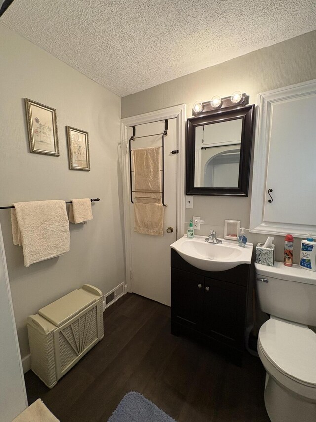 2065 Reggie Dr, Benton Harbor, MI 49022 - bathroom with vanity, wood finished floors, a textured ceiling, and a shower