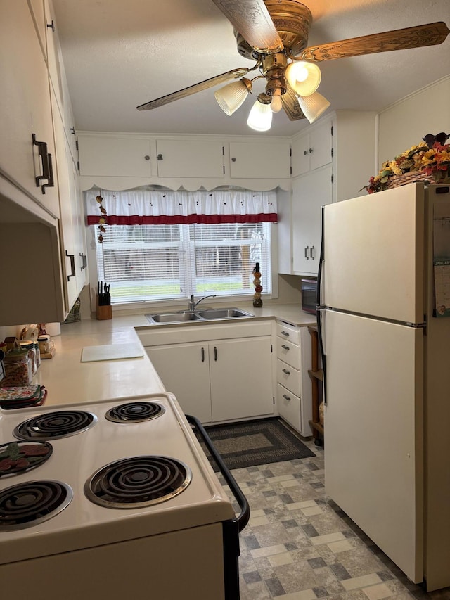 2065 Reggie Dr, Benton Harbor, MI 49022 - kitchen featuring white appliances, healthy amount of natural light, a ceiling fan, and white cabinetry