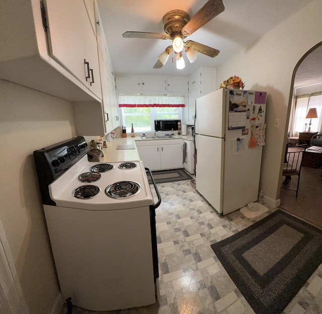 2065 Reggie Dr, Benton Harbor, MI 49022 - kitchen featuring white appliances, a ceiling fan, light countertops, white cabinetry, and arched walkways