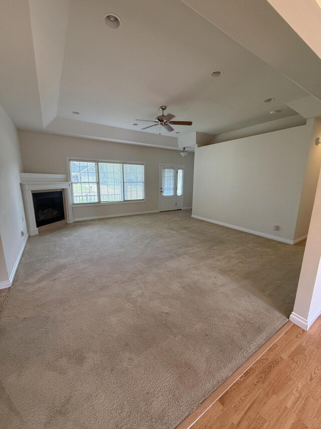 5798 Wacker Dr, Stevensville, MI 49127 - unfurnished living room featuring a ceiling fan, a fireplace, light wood-style floors, light colored carpet, and recessed lighting