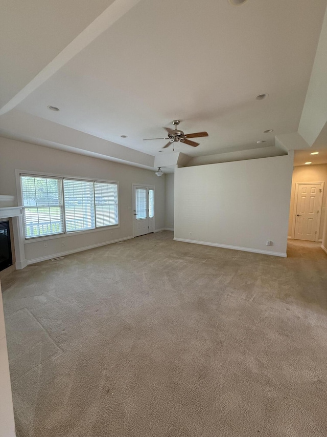 5798 Wacker Dr, Stevensville, MI 49127 - unfurnished living room featuring light colored carpet, ceiling fan, a glass covered fireplace, and recessed lighting