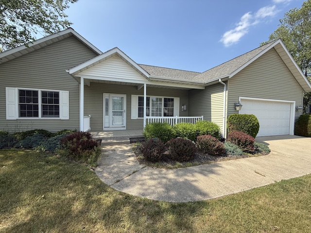 5798 Wacker Dr, Stevensville, MI 49127 - ranch-style home with covered porch, a garage, a shingled roof, concrete driveway, and a front lawn