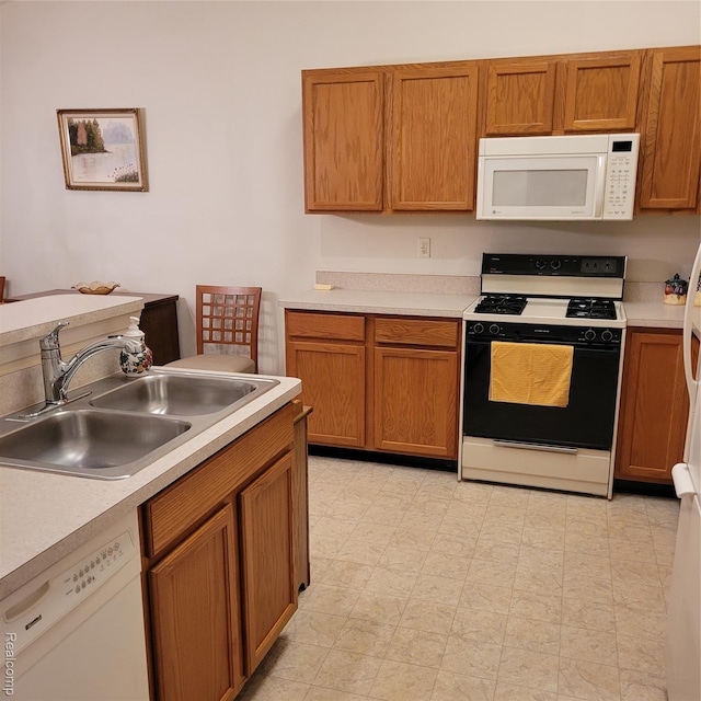 22865 Woodcreek Dr, Taylor, MI 48180 - kitchen featuring white appliances, light countertops, and brown cabinets
