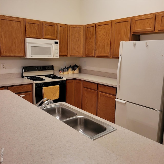 22865 Woodcreek Dr, Taylor, MI 48180 - kitchen featuring white appliances, light countertops, and brown cabinets