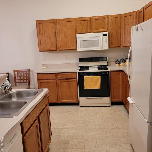 22865 Woodcreek Dr, Taylor, MI 48180 - kitchen with white appliances, light countertops, and brown cabinets