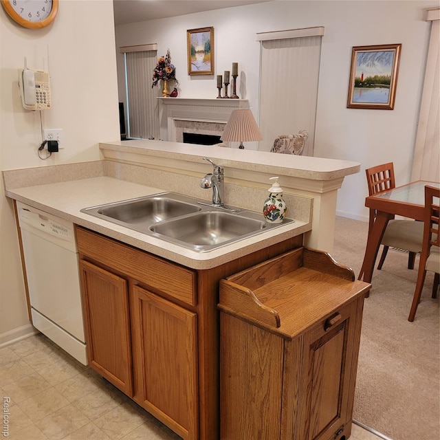 22865 Woodcreek Dr, Taylor, MI 48180 - kitchen featuring dishwasher, a fireplace, brown cabinetry, a peninsula, and light countertops