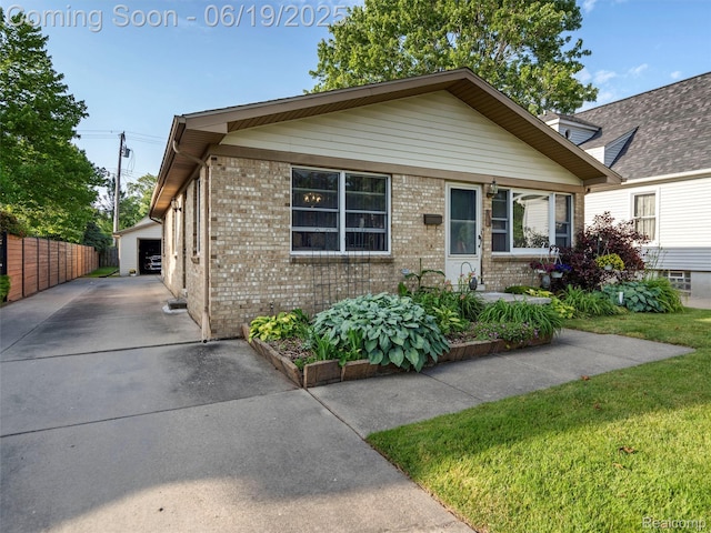 436 Orchard St, Wyandotte, MI 48192 - view of front facade featuring brick siding, a garage, and an outbuilding