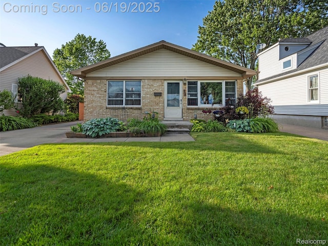 436 Orchard St, Wyandotte, MI 48192 - view of front of house with brick siding and a front lawn
