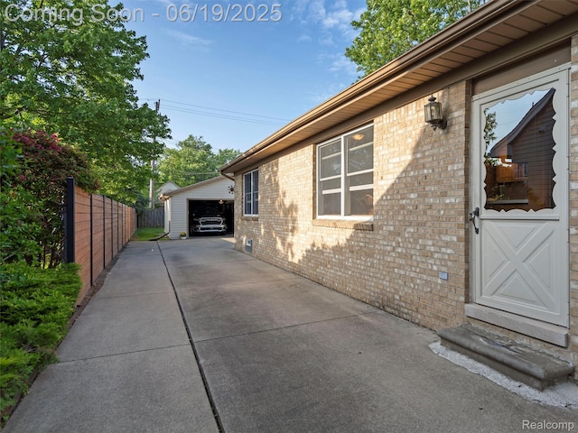 436 Orchard St, Wyandotte, MI 48192 - view of property exterior featuring brick siding, an outdoor structure, and a garage