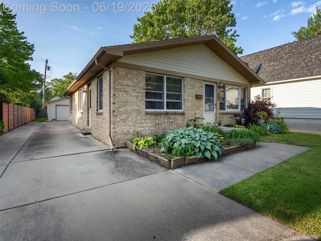 436 Orchard St, Wyandotte, MI 48192 - view of front facade featuring an outdoor structure, a detached garage, and brick siding