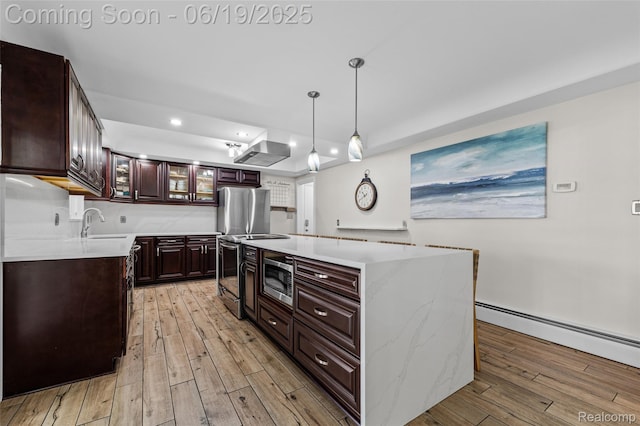 49775 Keycove St, Chesterfield, MI 48047 - kitchen with light wood-style floors, light countertops, a baseboard heating unit, a tray ceiling, and stainless steel microwave