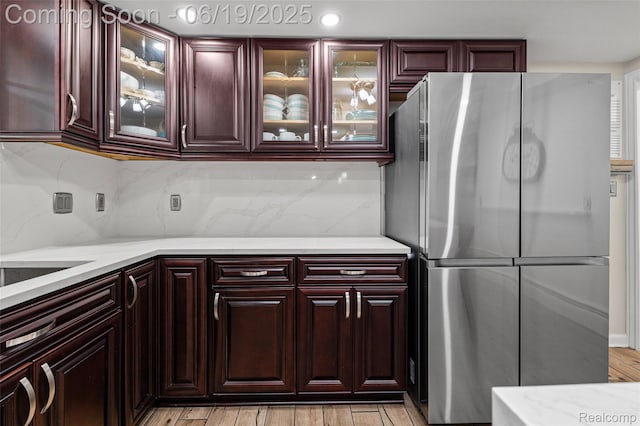 49775 Keycove St, Chesterfield, MI 48047 - kitchen with freestanding refrigerator, light wood finished floors, and decorative backsplash