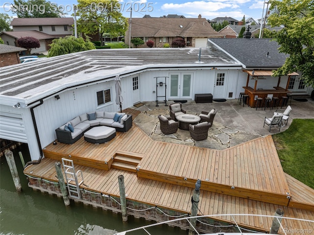 49775 Keycove St, Chesterfield, MI 48047 - rear view of house with french doors, an outdoor hangout area, a deck with water view, a patio, and a residential view