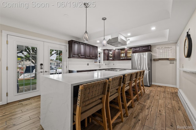 49775 Keycove St, Chesterfield, MI 48047 - kitchen featuring freestanding refrigerator, baseboard heating, light wood-style flooring, light countertops, and recessed lighting