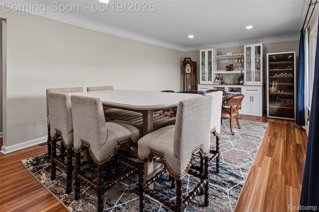 49775 Keycove St, Chesterfield, MI 48047 - dining room featuring beverage cooler, a bar, crown molding, light wood finished floors, and recessed lighting