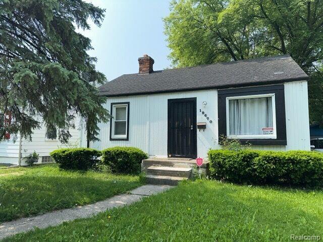 19670 Mccormick St, Detroit, MI 48224 - view of front of home featuring a chimney and a front yard