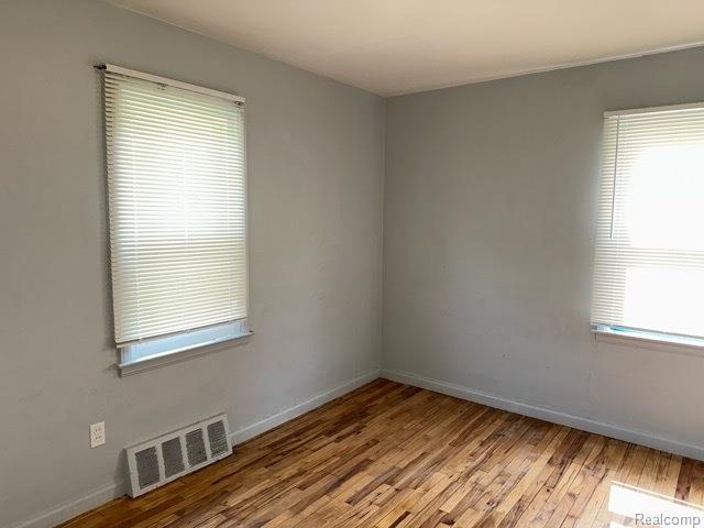 19670 Mccormick St, Detroit, MI 48224 - empty room with light wood-style floors and baseboards