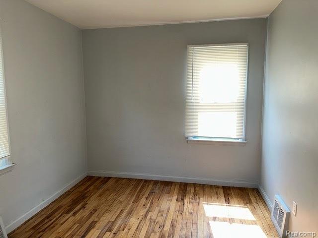 19670 Mccormick St, Detroit, MI 48224 - spare room featuring hardwood / wood-style flooring and healthy amount of natural light