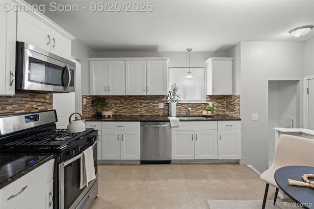 339 Shotka St, Westland, MI 48186 - kitchen with stainless steel appliances, tasteful backsplash, white cabinets, and dark stone counters