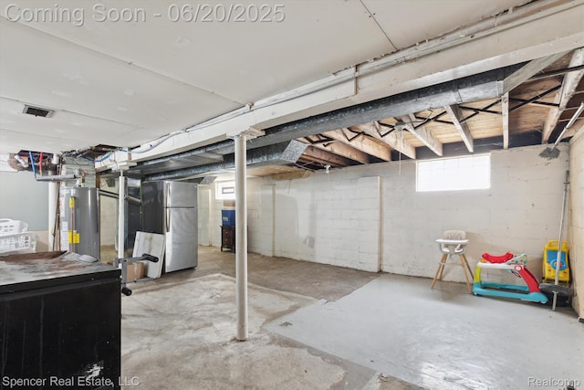 17398 Hanna St, Melvindale, MI 48122 - basement with water heater, heating unit, and freestanding refrigerator