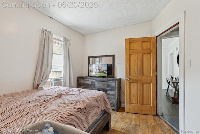 17398 Hanna St, Melvindale, MI 48122 - bedroom with wood finished floors, a textured ceiling, and cooling unit