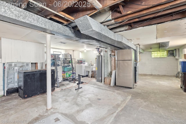17398 Hanna St, Melvindale, MI 48122 - below grade area featuring plenty of natural light, heating unit, gas water heater, and separate washer and dryer