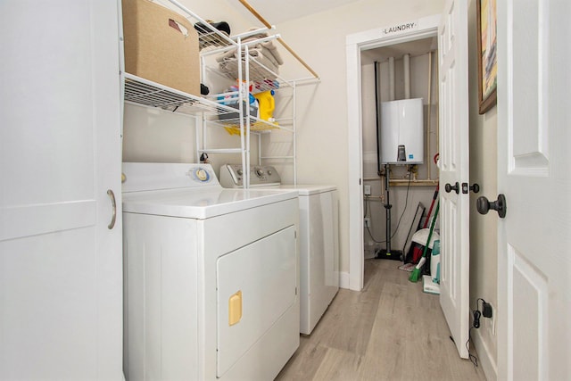 701 E Alice St, Whitehall, MI 49461 - washroom featuring water heater, separate washer and dryer, and light wood-type flooring