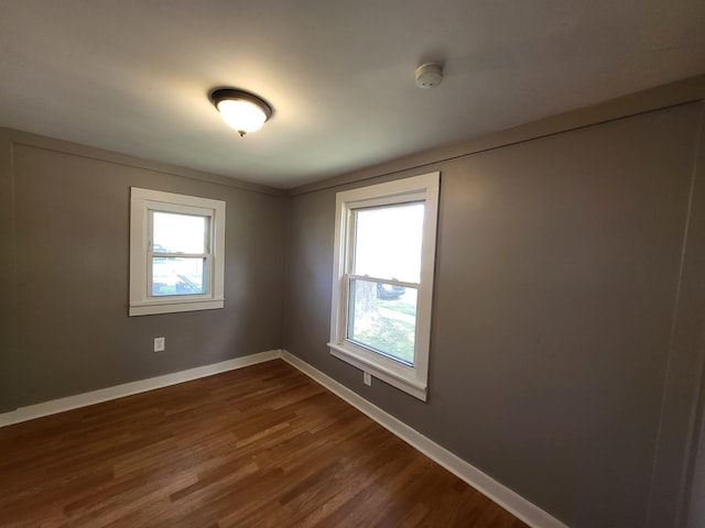 23077 Piper Ave, Eastpointe, MI 48021 - spare room with dark wood finished floors and a smoke detector