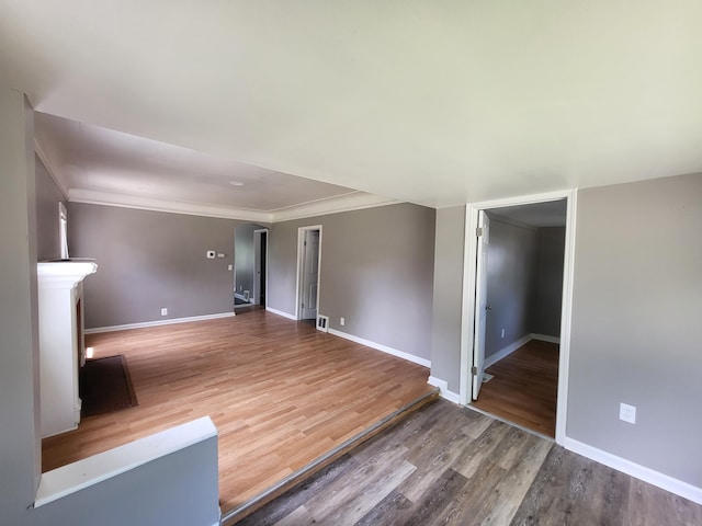 23077 Piper Ave, Eastpointe, MI 48021 - empty room with arched walkways, wood finished floors, and ornamental molding