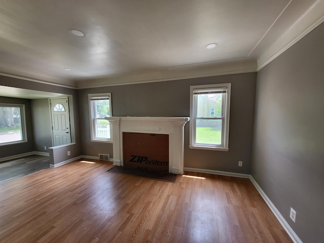 23077 Piper Ave, Eastpointe, MI 48021 - unfurnished living room featuring wood finished floors, a fireplace with flush hearth, crown molding, and recessed lighting