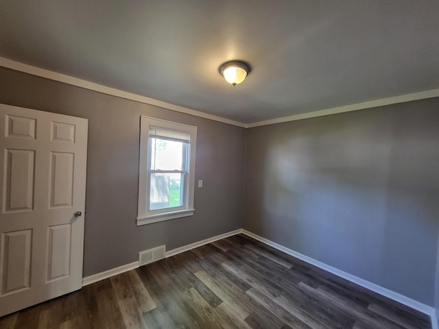 23077 Piper Ave, Eastpointe, MI 48021 - spare room with dark wood-style floors and ornamental molding