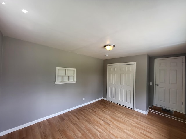 23077 Piper Ave, Eastpointe, MI 48021 - unfurnished bedroom with light wood finished floors and a closet