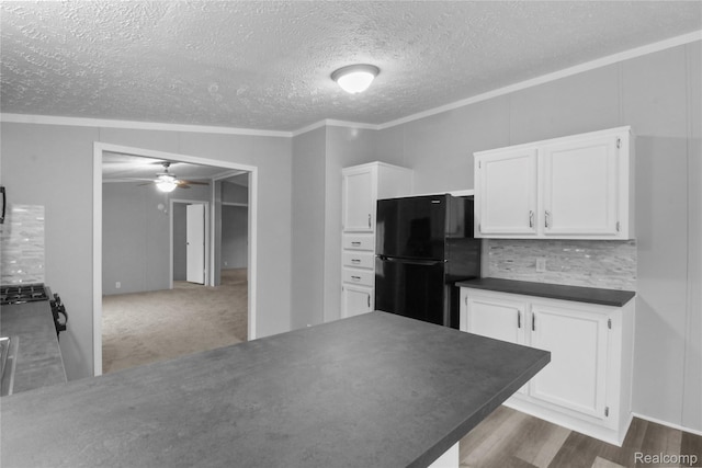 39500 W Warren Rd, Canton, MI 48187 - kitchen featuring freestanding refrigerator, a ceiling fan, white cabinets, dark countertops, and a textured ceiling