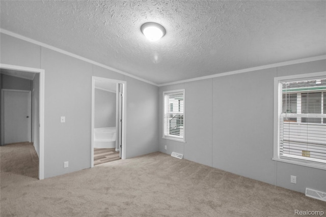 39500 W Warren Rd, Canton, MI 48187 - unfurnished bedroom with crown molding, carpet flooring, a textured ceiling, vaulted ceiling, and connected bathroom
