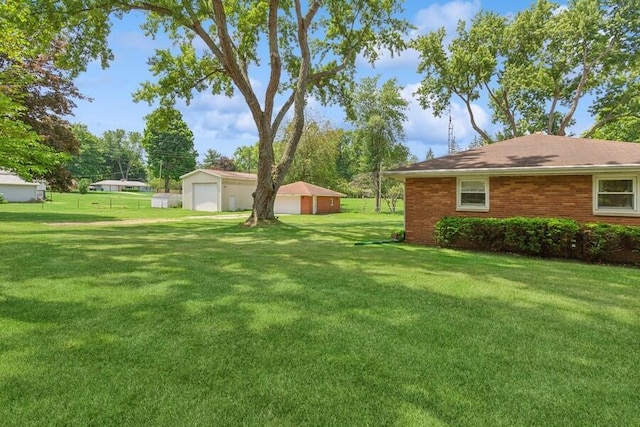 3202 Niles Buchanan Rd, Buchanan, MI 49107 - view of grassy yard featuring a detached garage and an outbuilding