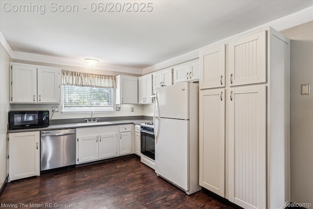 49212 Kimberly Ann Ln, Chesterfield, MI 48051 - kitchen featuring stainless steel dishwasher, black microwave, freestanding refrigerator, range with gas stovetop, and dark wood finished floors