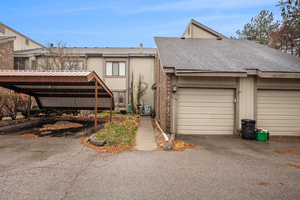 7445 Radcliff Ct, West Bloomfield, MI 48322 - view of front facade with driveway, a shingled roof, and an attached garage