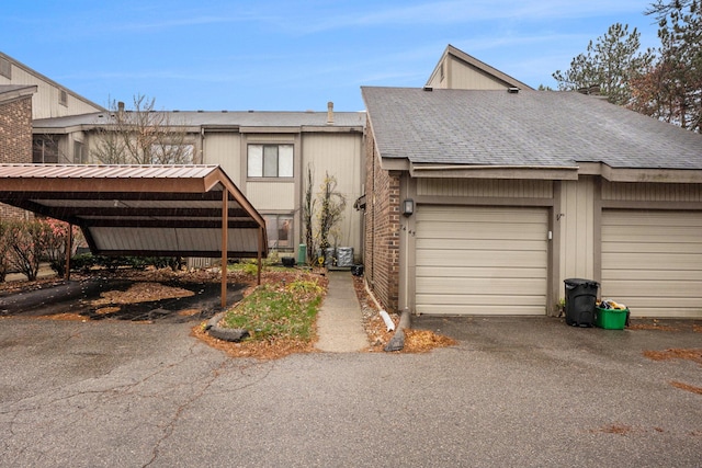 7445 Radcliff Ct, West Bloomfield, MI 48322 - view of front facade with driveway, a shingled roof, and an attached garage