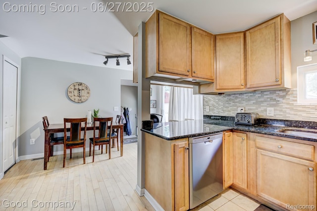3626 Prairie Ave, Berkley, MI 48072 - kitchen with stainless steel dishwasher, rail lighting, decorative backsplash, dark stone countertops, and a peninsula