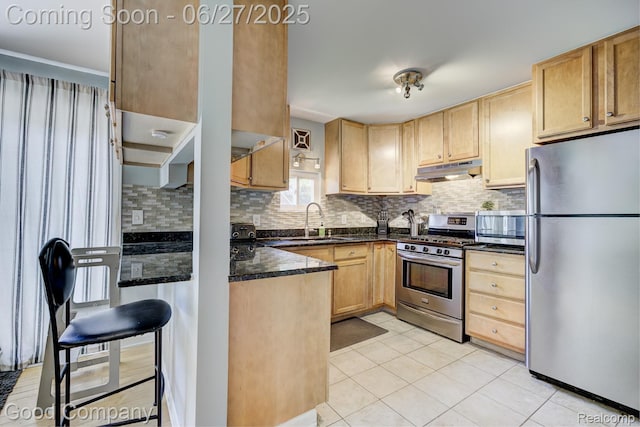 3626 Prairie Ave, Berkley, MI 48072 - kitchen with stainless steel appliances, under cabinet range hood, light tile patterned floors, backsplash, and light brown cabinetry