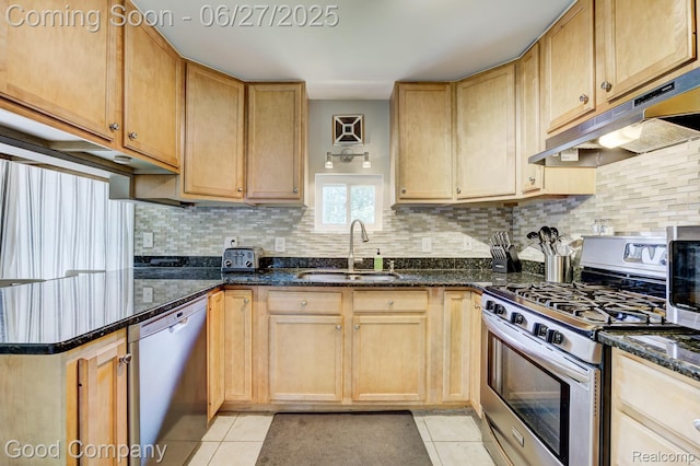 3626 Prairie Ave, Berkley, MI 48072 - kitchen with appliances with stainless steel finishes, under cabinet range hood, light tile patterned floors, tasteful backsplash, and dark stone countertops