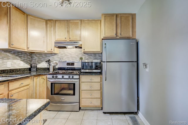 3626 Prairie Ave, Berkley, MI 48072 - kitchen featuring appliances with stainless steel finishes, under cabinet range hood, light tile patterned floors, decorative backsplash, and dark stone countertops