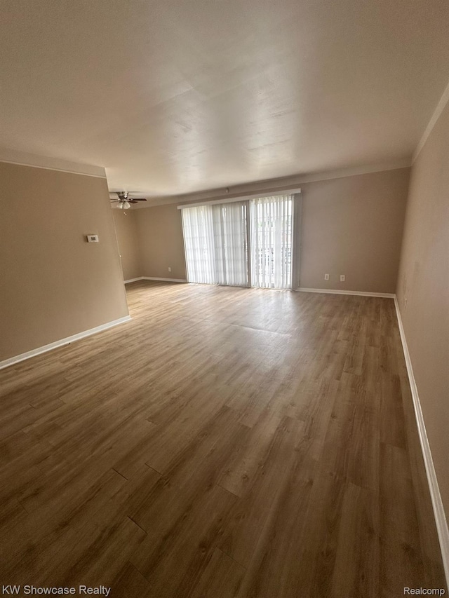 490 N Fox Hills Dr N Unit 2, Bloomfield Hills, MI 48304 - spare room with ornamental molding, wood finished floors, and ceiling fan