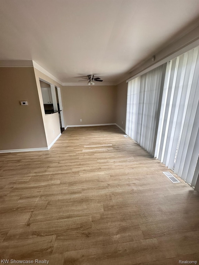 490 N Fox Hills Dr N Unit 2, Bloomfield Hills, MI 48304 - spare room featuring a ceiling fan, wood finished floors, and crown molding