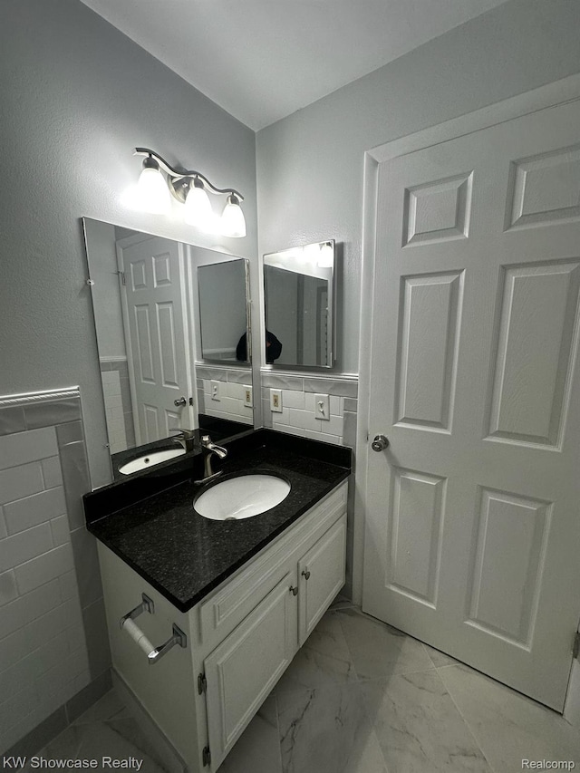 490 N Fox Hills Dr N Unit 2, Bloomfield Hills, MI 48304 - bathroom with marble finish flooring, vanity, and tile walls