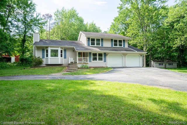 3485 Burrus Ct, Ortonville, MI 48462 - tri-level home featuring asphalt driveway, a chimney, covered porch, and a front yard