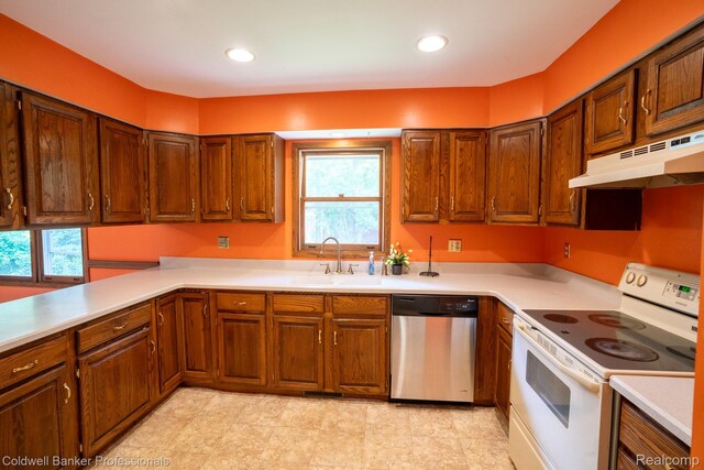3485 Burrus Ct, Ortonville, MI 48462 - kitchen featuring white range with electric stovetop, stainless steel dishwasher, healthy amount of natural light, under cabinet range hood, and recessed lighting
