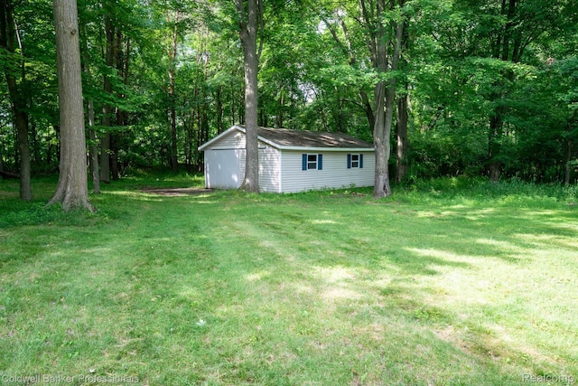 3485 Burrus Ct, Ortonville, MI 48462 - view of green lawn with an outbuilding and a detached garage